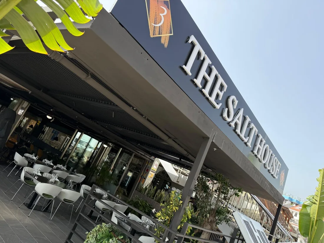 The Salt House sign above the terrace on a sunny day